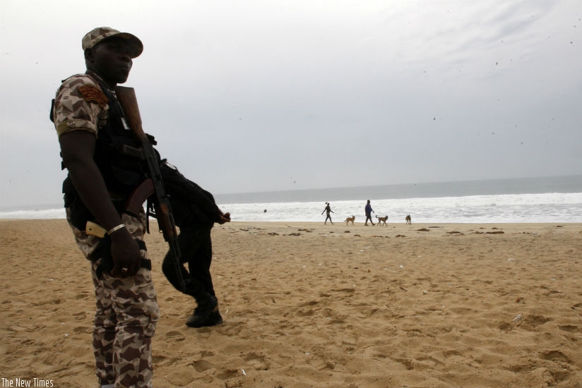An Ivorian soldier stands guard on March 18, 2016 at the site of a jihadist shooting rampage at the beach resort of Grand Bassam. (Internet photo)