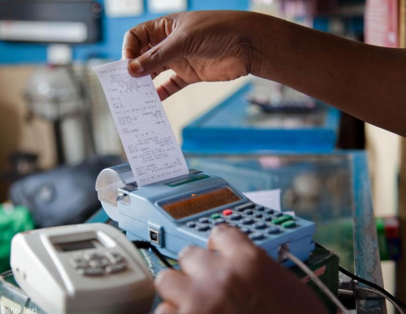 A trader pulls a receipt out of an EBM. (File)