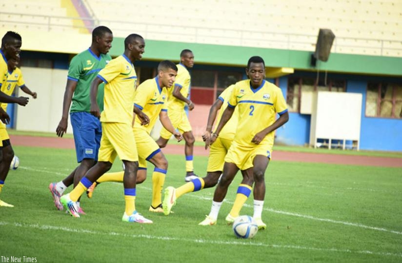Amavubi players enjoy their training with assistant coach Jimmy Mulisa (left) on Wednesday. The team departed for Belle-Vue yesterday. (Courtesy)