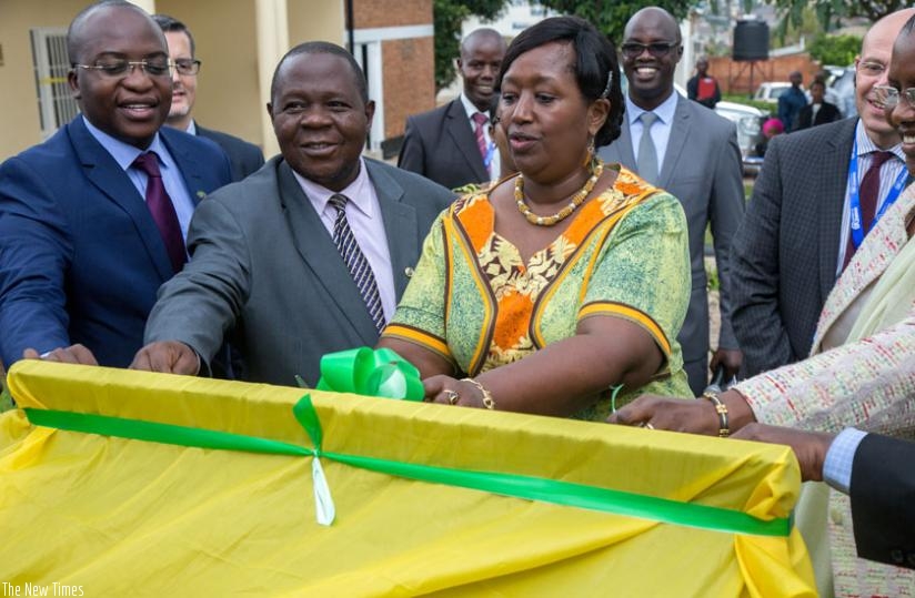 Minister Binagwaho (C) cuts a ribbon with other regional dignitaries to launch the EAC health centre of excellence in Kigali yesterday. (Doreen Umutesi)