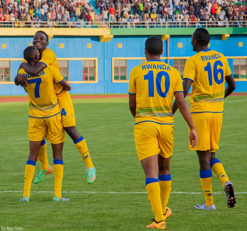 Jean Baptiste Mugiraneza (No. 7) celebrates his late goal with Muhadjiri Hakizimana, to complete Rwanda's 5-0 rout of Mauritius at Amahoro National Stadium in Kigali yesterday. (Faustin Niyigena)