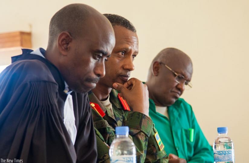 Byabagamba (C) and Rusagara (R) before Military High Court in Kanombe, yesterday. (Faustin Niyigena)