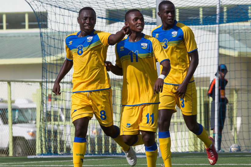 Blaise Itangishaka (L) celebrates with teammates after giving Rwanda the lead against Uganda yesterday at Kigali Regional Stadium. (Timothy Kisambira)
