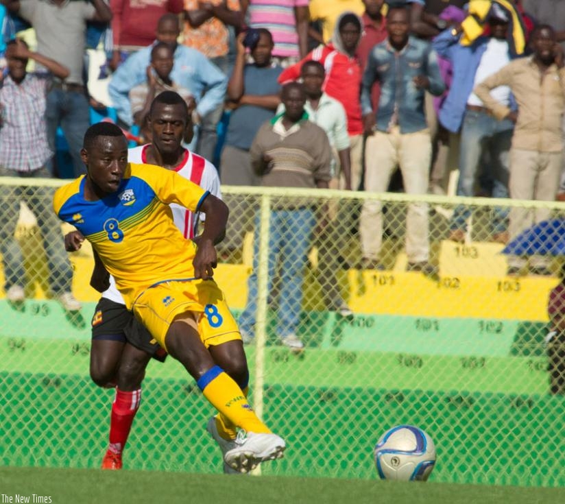 U-20 national team forward Blaise Itangishaka passes the ball during the game against Uganda on Saturday. He scored in the 1-1 draw. (T. Kisambira)