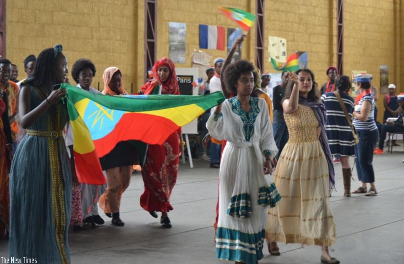 Students march with flags from different countries. (Julius Bizimungu)