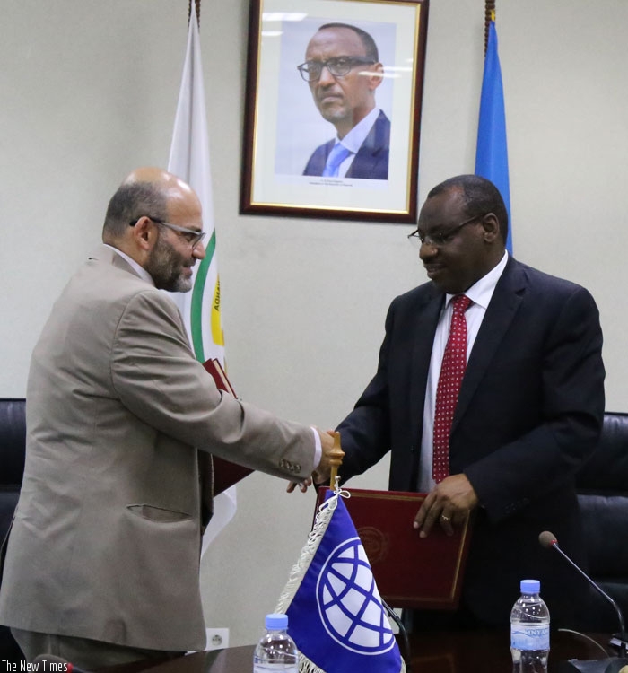WB Rwanda chief Yasser El-Gamal (left) and Gatete exchange documents after signing the funding agreement on Wednesday in Kigali.  (Courtesy)