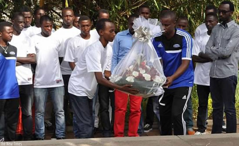 Dream Team FA coaches and players lay a wreath at a mass grave at Kigali Genocide Memorial  Centre last year. (File)