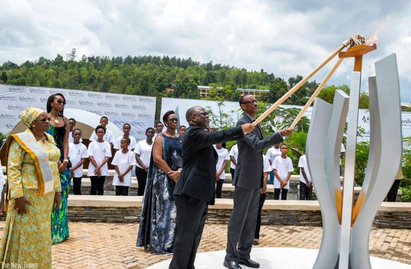 Presidents Kagame and Magufuli light the Flame of Remembrance at the Kigali Genocide Memorial Centre to mark the beginning of the 22nd commemoration of the 1994 Genocide against th....