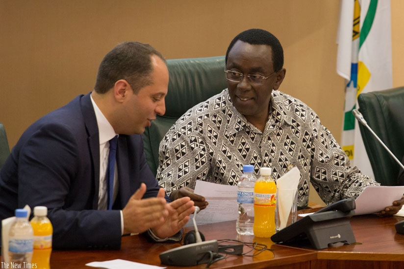 Abtan Benjamin, the president of EGAM (L), chats with Bernard Makuza, the Senate president, during the meeting yesterday. (Timothy Kisambira)