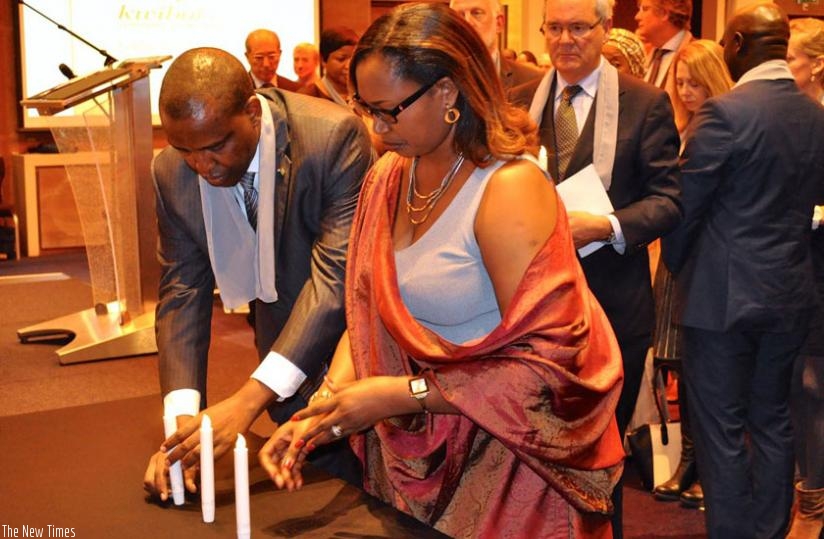 Amb. Karabaranga and his wife light a candle during the commemoration event in Netherlands. (Courtesy)