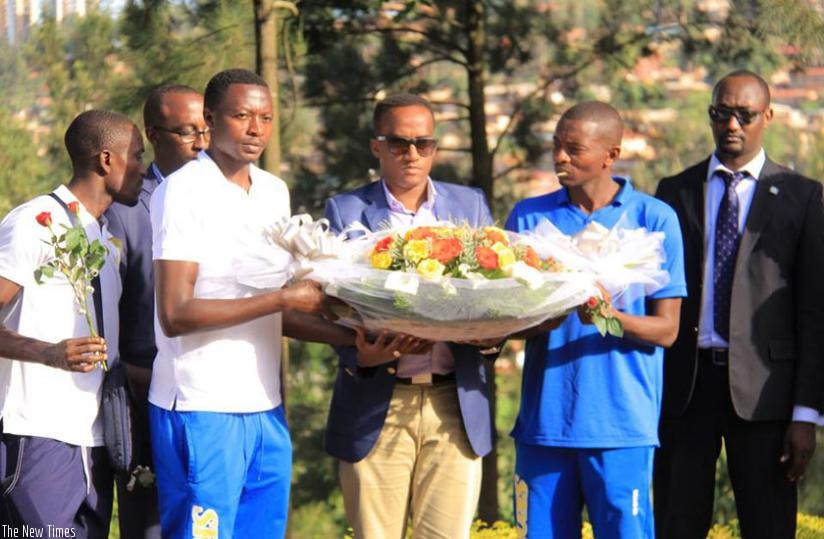 Rayon Sports FC officials and players  laying the wreath at the Kigali Genocide Memorial Center at Gisozi on Wednesday. (Jejje Muhinde)