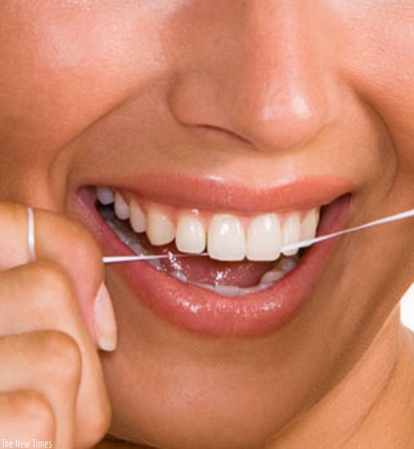 Flossing helps remove food particles from teeth and prevents gum diseases. (Internet photo)