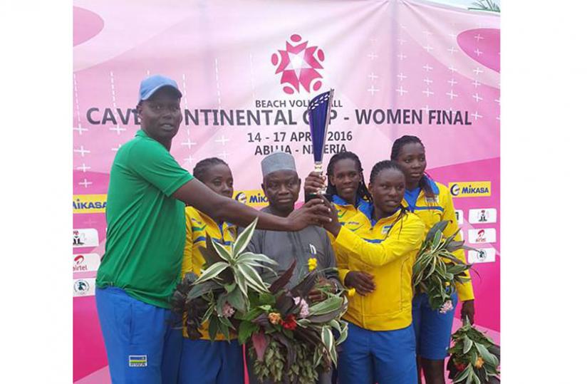 Rwanda's coach Paul Bitok and Team Rwanda receive their trophy after finishing as losing finalists in the final. (Courtesy)