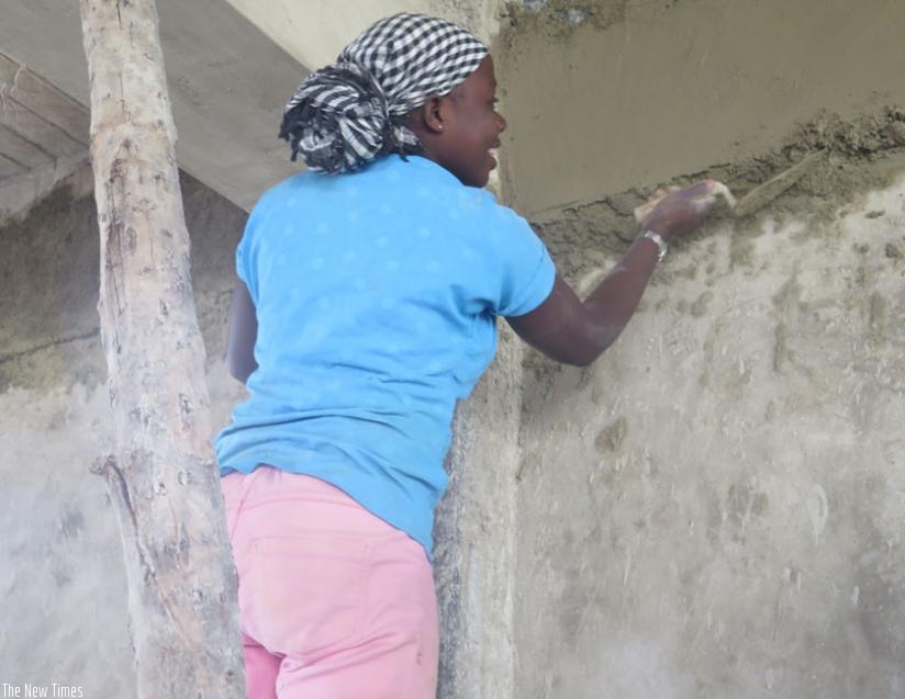 A woman builder at a construction site in Kimihurura. Women are still underpaid by site owners. (Lydia Atieno)
