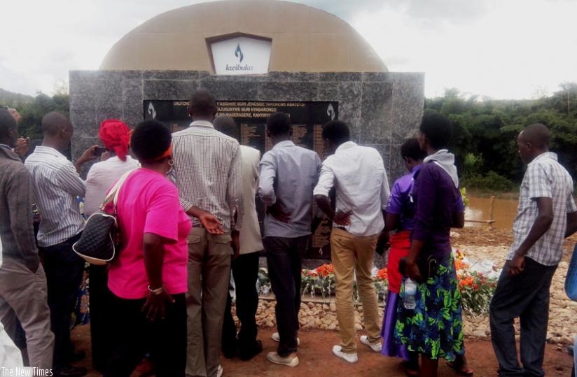 Mourners look at the names of the 755 victims of the 1994 Genocide against the Tutsi on a monument erected on the banks of Nyabarongo River on Saturday. (Emmanuel Ntirenganya)