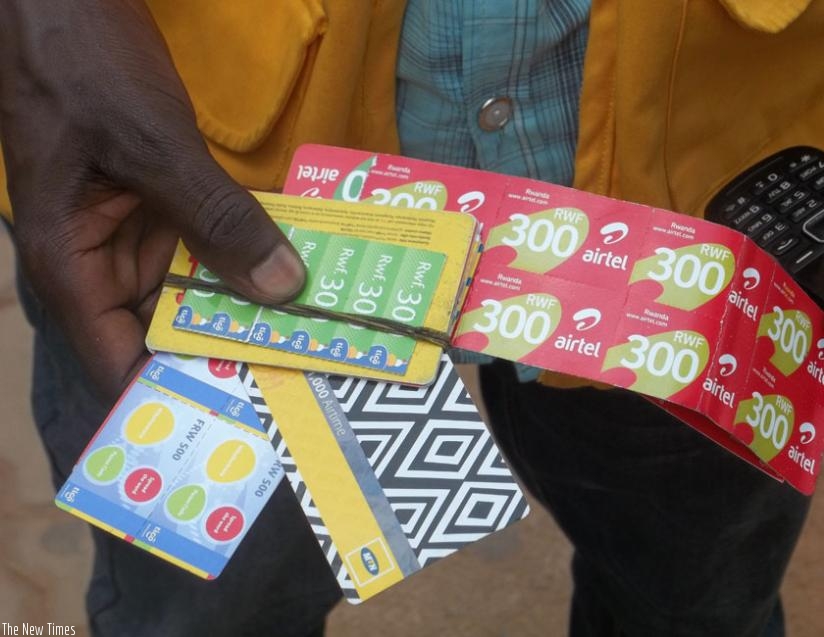 A vendor sells airtime cards of all the three telecom firms operating in Rwanda. There are over 8.8 million Rwandans with mobile phone presently. (File)