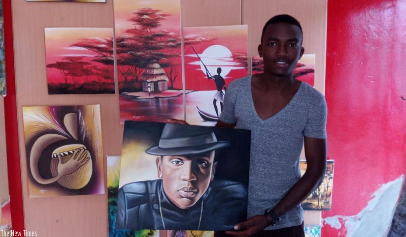 Girihirwe poses with his finished piece of R&B singer Christopher Muneza.