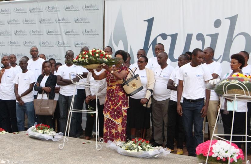 Staff of I&M Bank lay a wreath on the grave at Gisozi Genocide memorial centre. (Francis Byaruhanga)