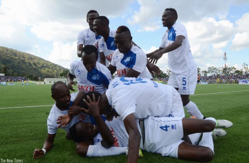 Rayon Sports' Thierry Manzi and his teammates cerebrate his goal against AS Kigali at Nyamirambo stadium, yesterday. (Sam Ngendahimana)