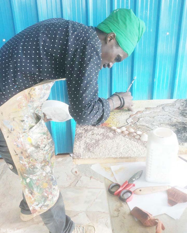 The artist works on a piece. 