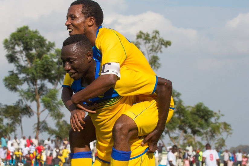 Blaise Itangishaka carries Dominique-Savio Nshuti, who set him up for Rwanda U-20 team's goal against Uganda Hippos in the first leg. (Timothy Kisambira)