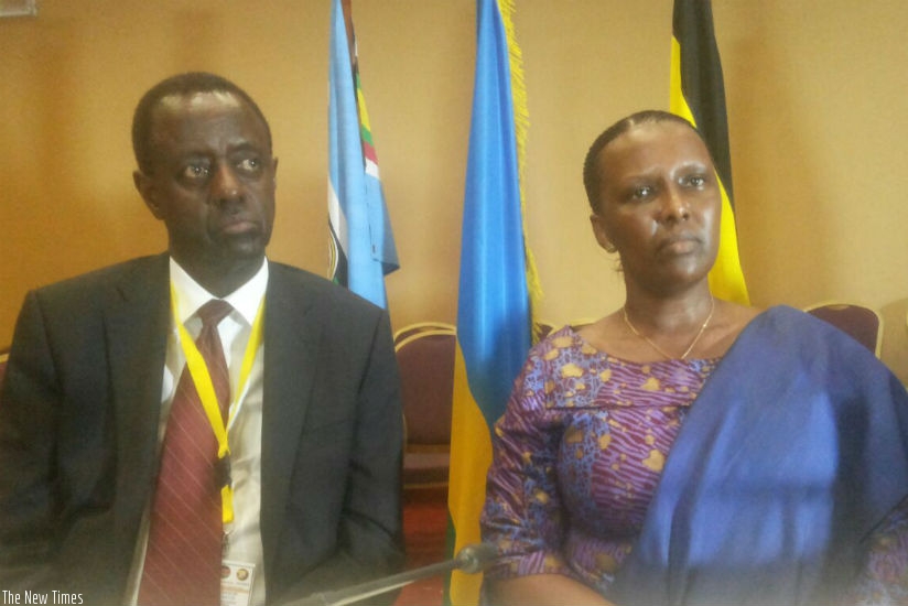 EAC Affairs Minister Valentine Rugwabiza and Uganda's ICT Minister John Nasasira speaking to journalists in Kampala ahead of the NCIP summit today. (Courtesy)