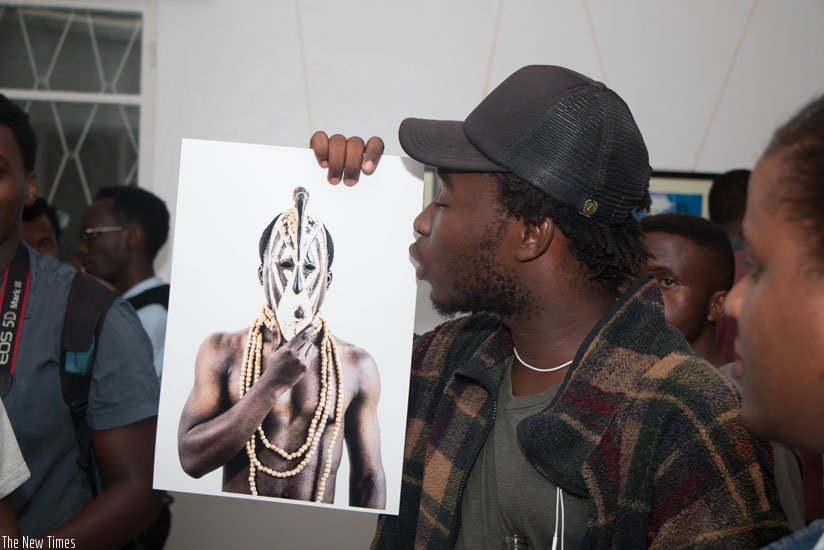 Jacques Nkinzingabo shows off one of his photos. (Moses Opobo)