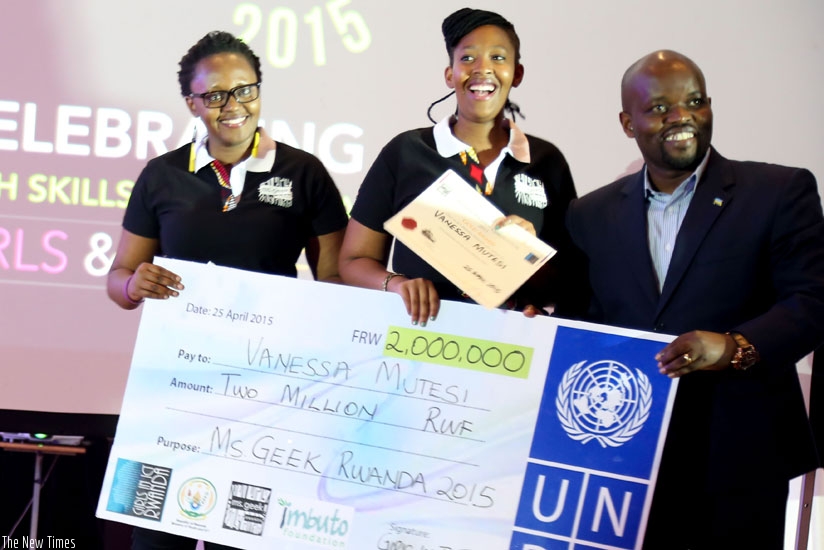 Last year's Ms. Geek winner Vanessa Mutesi (C)  receives a dummy cheque from (R) Jean-Philbert Nsengimana, Minister for Youth and ICT. Left is Lucy Mbabazi, President of Girls in I....