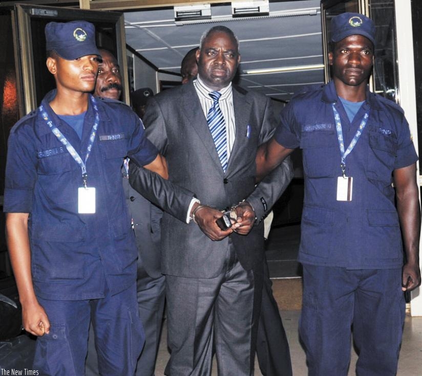 Genocide suspect Bernard Munyagishari (C) upon arrival at the Kigali International Airport in July, 2013. He was transferred to Rwanda by the International Criminal Tribunal for Rw....