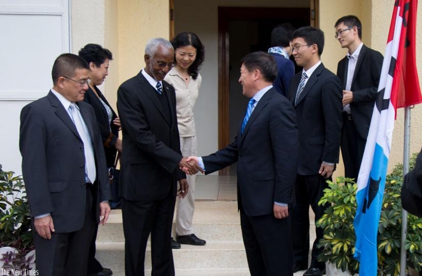 RPF Secretary-General Francois Ngarambe (L) shakes hands with Wang Heming, the deputy director-general for African Affairs in the Communist Party of China, in Kigali yesterday. (Ti....