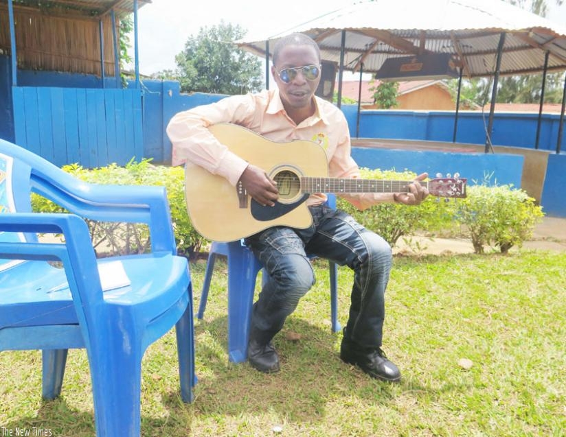 Alexandre Mwitende plays the guitar. (Hudson Kuteesa)