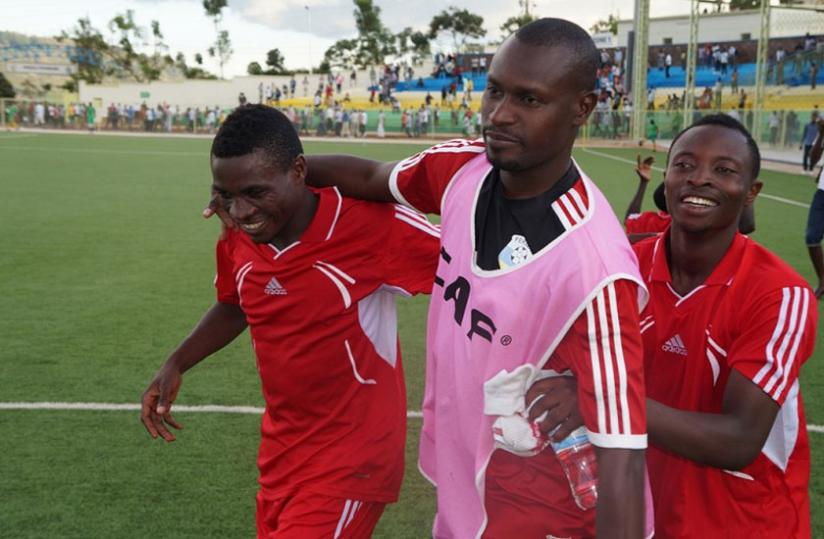 Etincelles' coach  Innocent Seninga (C) with some of his players after beating APR last week. (P. Kamasa)