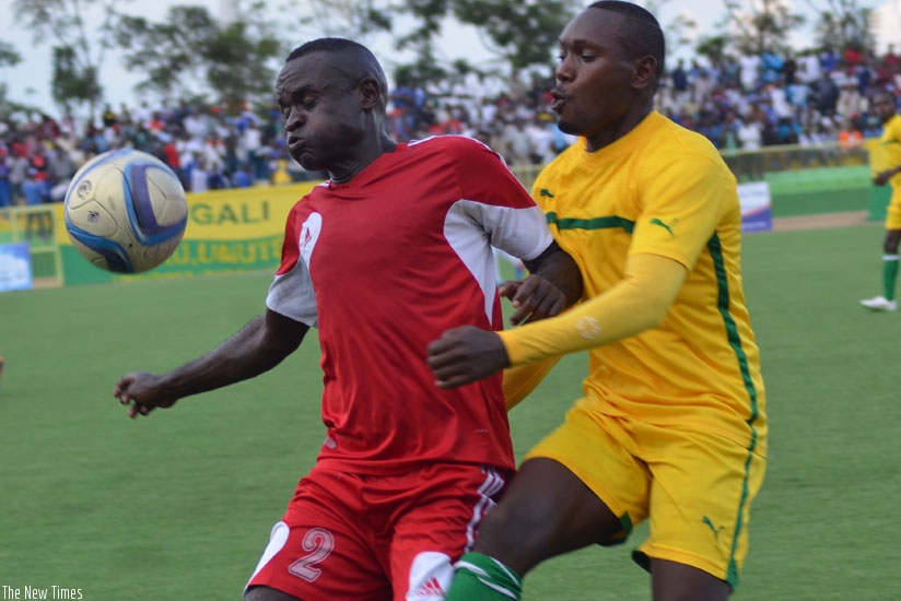 Marine FC's former Amavubi defender  Bonaventure Hategekimana (L) shields the ball against AS Kigali's striker Murengezi on Saturday. rn(Sam Ngendahimana)
