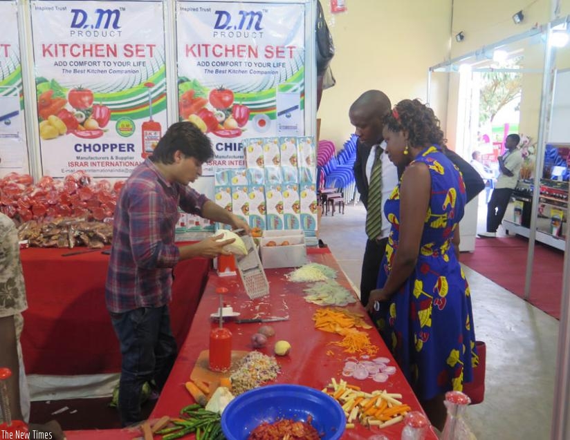 An exhibitor demonstrates how modern kitchenware works at the expo. (Francis Byaruhanga) 