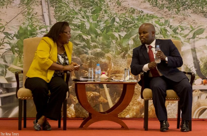 Agriculture minister Geraldine Mukeshimana (L) chats with Jean Philbert Nsengimana, the Minister for Youth and ICT, during the launch of Rwanda Youth in Agribusiness Forum in Kigal....
