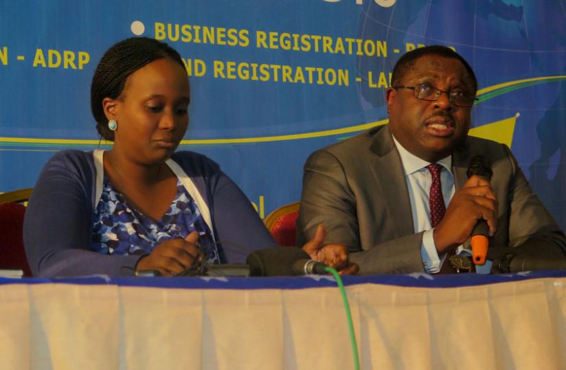 IGF CEO, Asiko (R) speaking during a press conference at the closing ceremony of the ICF funded business environment projects as Kanyonga, the Registrar General at RDB (L) looks on....