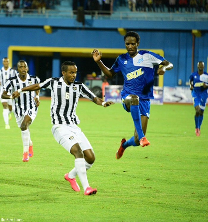 APR midfieder Yannick Mukunzi under pressure from Rayon Sportsu2019 Davis Kasirye, clears his lines on Tuesday at Amahoro National Stadium. APR lost the game 4-0. (Sam Ngendahimana)