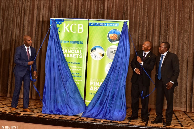 Celestin Rwabukumba (far left) and  Maurice Toroitich unveil KCB Bank Rwanda's Custody Services as Robert Mathu looks on in Kigali yesterday. (P. Tumwebaze)