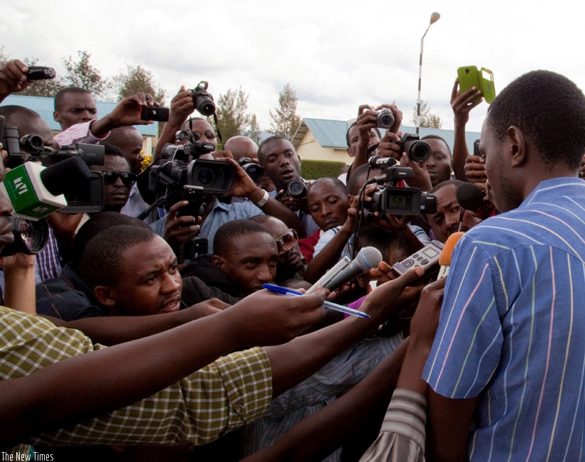 Journalists interview a suspect at Kacyiru Police headquarters last year. (Timothy Kisambira)