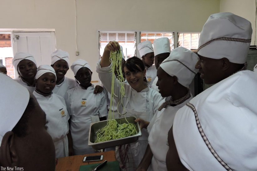 Bianco (C) shows students at Esthers Aid Culinary School how to prepare salads. (Solomon Asaba)