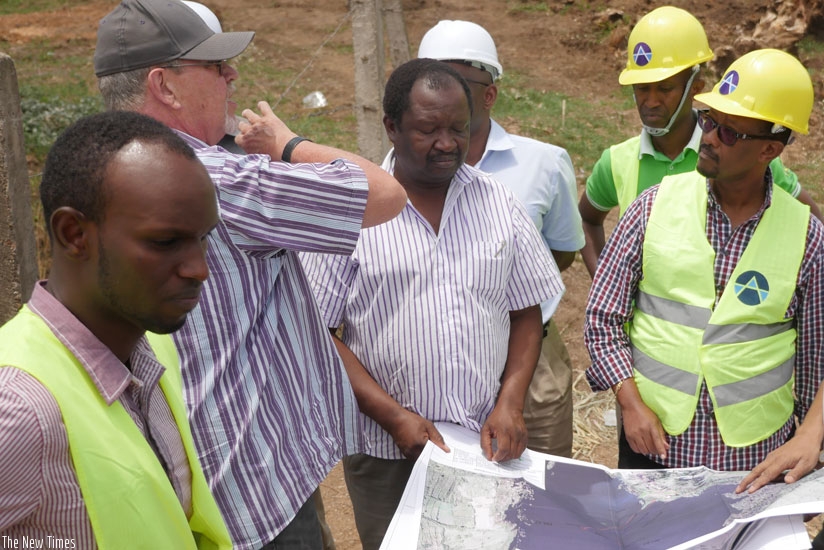 Dr Canisius Kanangire (R) Lake Victoria Basin Commission Executive Secretary and water and sanitation experts from across EAC inspect Water Plant Designs in Nyanza District, Southe....