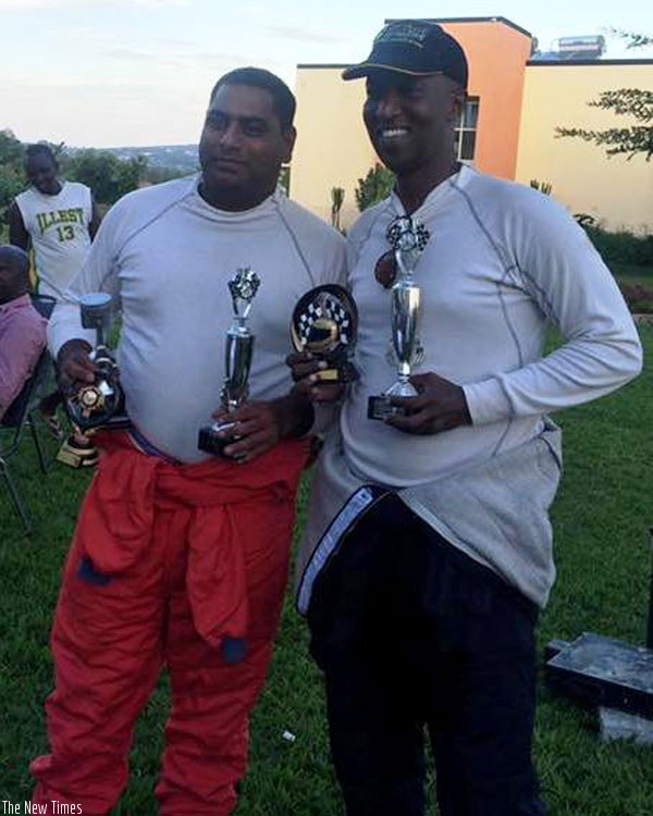 Rally driver Mohammed Abbas Roshanali and his navigator Lee Youssef Habimana pose with their trophies. (J. Muhinde)