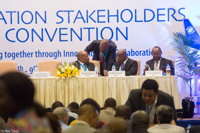 RwandAir CEO, John Mirenge consults with aviation expert during the 5th Africa Aviation Summit in Kigali. (T. Kisambira)