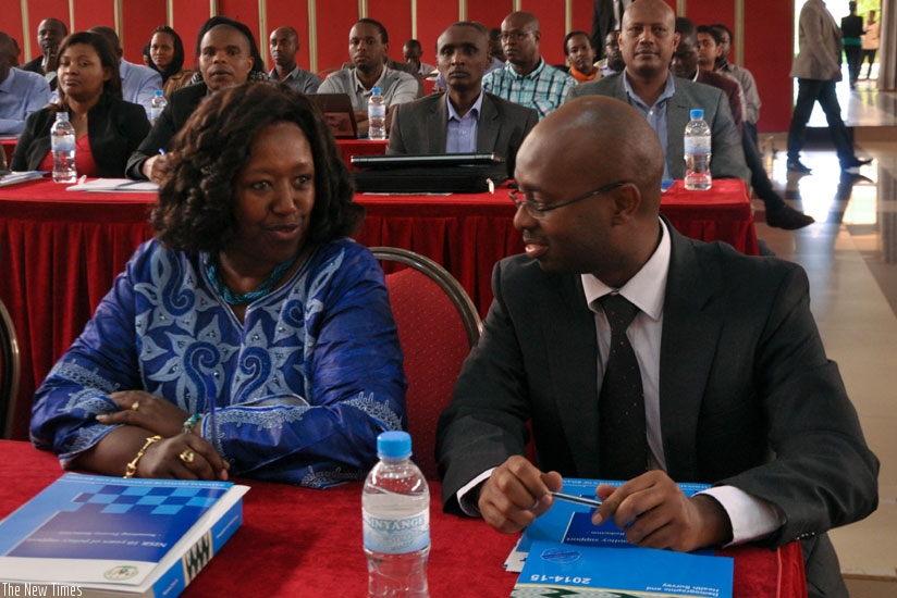 Dr Binagwaho (L) chats with Murangwa during the workshop yesterday in Kigali. (Teddy Kamanzi)