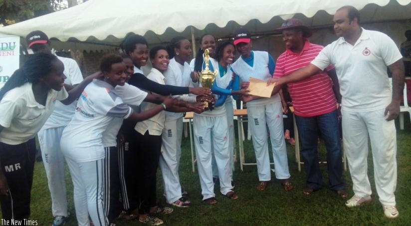 Charity CC players receive the trophy from RCA boss Charles Haba (2nd right) after defeating  White Clouds CC in the final on Sunday. (Pontian Kabeera)