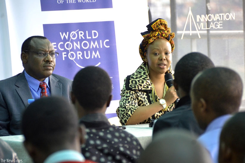 Finance and Economic Planning minister Claver Gatete (L) and Elsie Kanza, the head of WEF Africa division and member of the Executive Committee of World Economic Forum, address the....