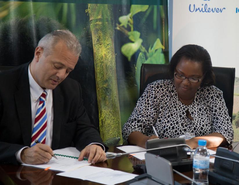 Camille Z.Chammas Unilever vice President Procumbent supply-Chain and sustainability (L) and Geraldine Mukeshimana, Agriculture Minister  sign the agreement. (T.Kisambira)