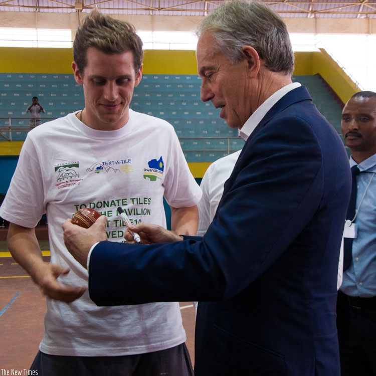 Head of Africa Governance Initiative, Tony Blair signs autograph on a cricket ball. (Teddy Kamanzi)