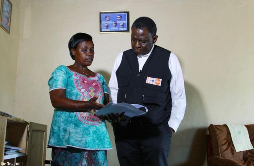 A community health worker explains to Dr Babatunde how they provide family planning services to community members  in Rwamagana District on Tuesday. (Courtesy)