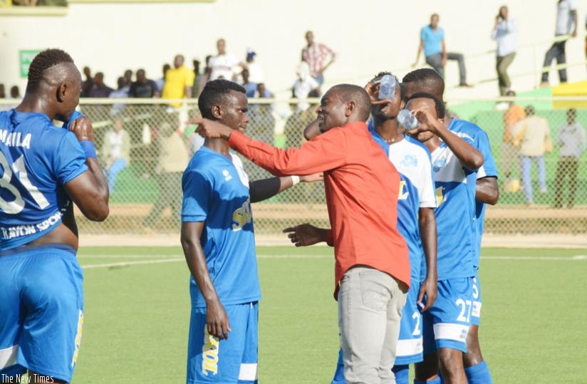 Rayon Sports coach Djuma Masudi gives instructions to his players on Wednesday at Kigali Regional Stadium. The blues thrashed Bugesera FC 4-0 to keep pressure on defending champion....